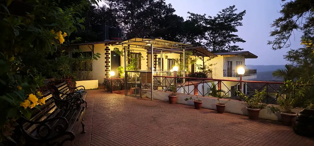 Hill Top Deluxe Cottage terrace at dusk at Cloud 9 Hills Resort
